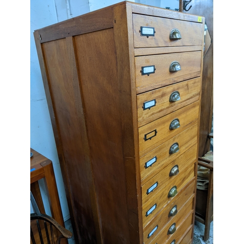 300 - A hardwood filing cabinet of twelve drawers with brass handles on stile feet 164cm x 57cm x 66cm Loc... 