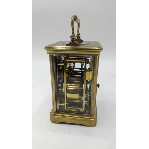 111 - An early 20th century French brass carriage clock, the dial painted with floral swags and having bla... 