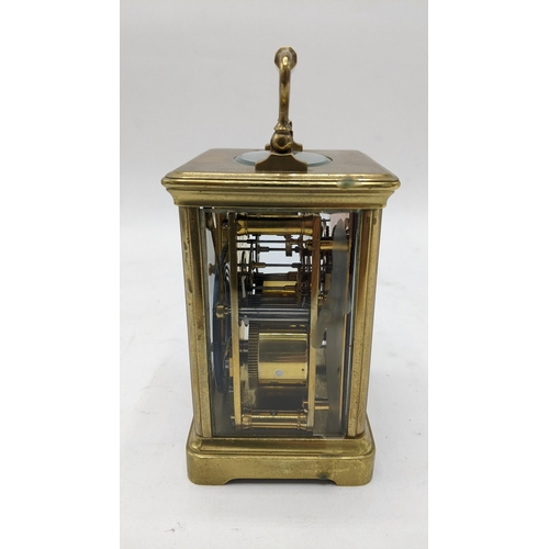 111 - An early 20th century French brass carriage clock, the dial painted with floral swags and having bla... 