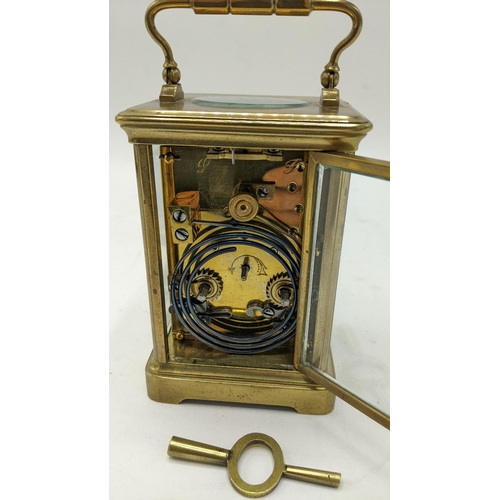 111 - An early 20th century French brass carriage clock, the dial painted with floral swags and having bla... 