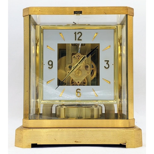 114 - A Jaeger Le Coultre Atmos clock circa 1960s, in a gilt brass case, having a square cream chapter rin... 