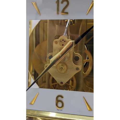 114 - A Jaeger Le Coultre Atmos clock circa 1960s, in a gilt brass case, having a square cream chapter rin... 