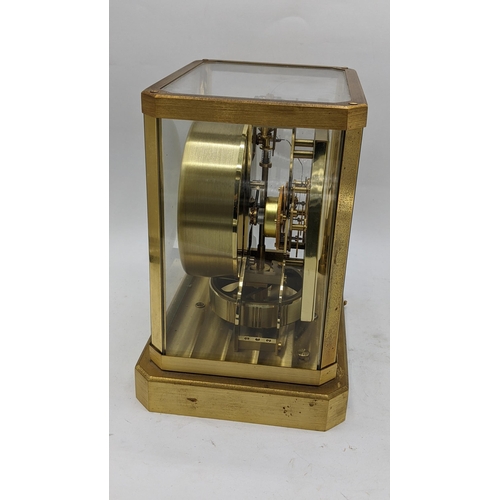 114 - A Jaeger Le Coultre Atmos clock circa 1960s, in a gilt brass case, having a square cream chapter rin... 