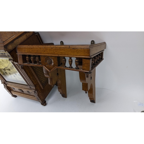 116 - A late 19th century oak bracket clock, the case of architectural design having a handle to the top e... 