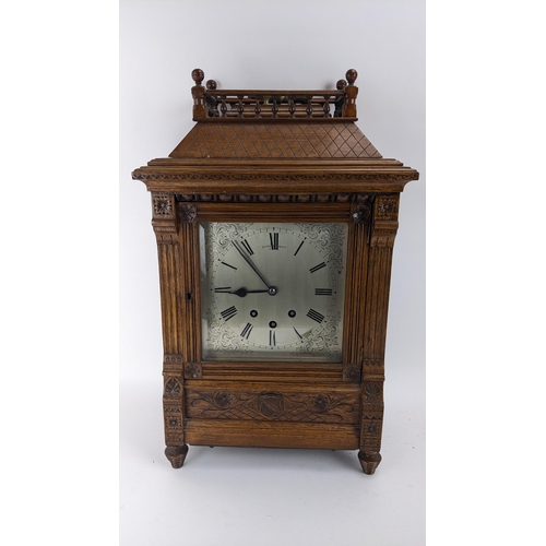 116 - A late 19th century oak bracket clock, the case of architectural design having a handle to the top e... 