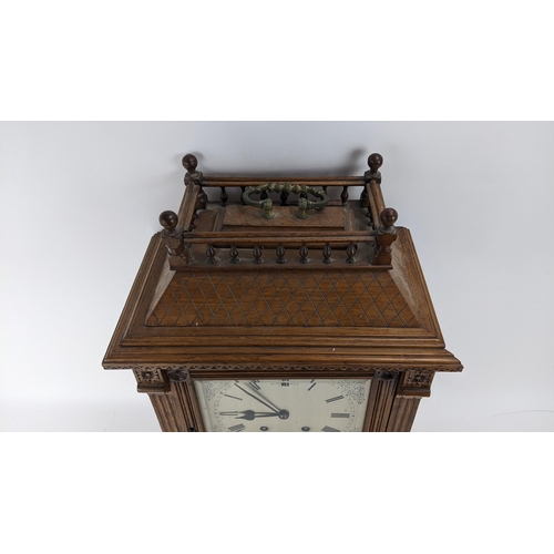 116 - A late 19th century oak bracket clock, the case of architectural design having a handle to the top e... 