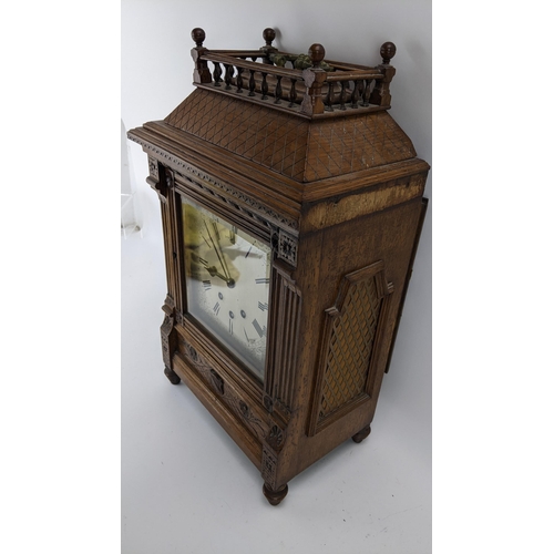 116 - A late 19th century oak bracket clock, the case of architectural design having a handle to the top e... 