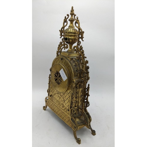 53 - A late 19th century French gilt metal mantle clock, the case having pierced scroll design with singl... 