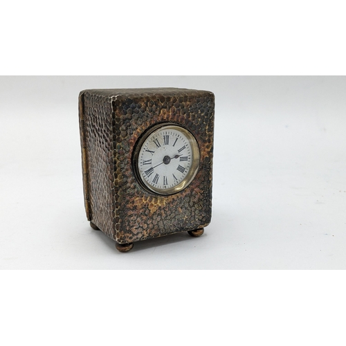 54 - An Edwardian Asprey silver dressing table clock, the case having hammered decoration, initialled 'E.... 