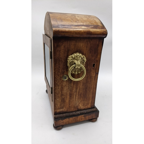 58 - A Regency mahogany bracket clock, the arched top case carved with scrolls, motif to the centre, bras... 