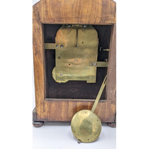 58 - A Regency mahogany bracket clock, the arched top case carved with scrolls, motif to the centre, bras... 