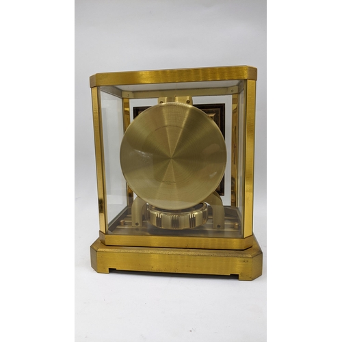 59 - A Jaeger Le Coultre Atmos clock circa 1960s, in a gilt brass case, having a square cream chapter rin... 