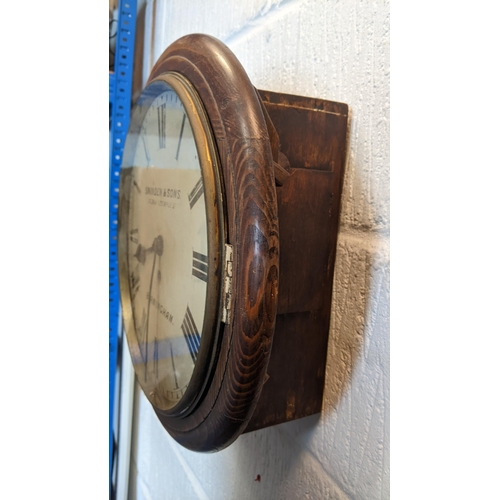 63 - A late 19th century 12 inch dial clock in an oak case, the dial inscribed 'Swinden & Sons 27.28 & 29... 