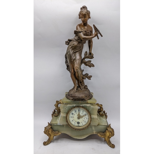 65 - A late 19th century French clock with matching garnitures, the onyx and gilt case having gilt metal ... 