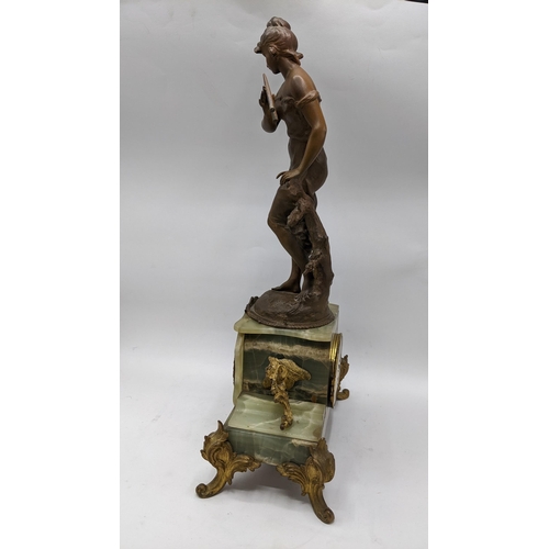 65 - A late 19th century French clock with matching garnitures, the onyx and gilt case having gilt metal ... 