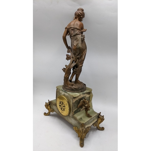 65 - A late 19th century French clock with matching garnitures, the onyx and gilt case having gilt metal ... 