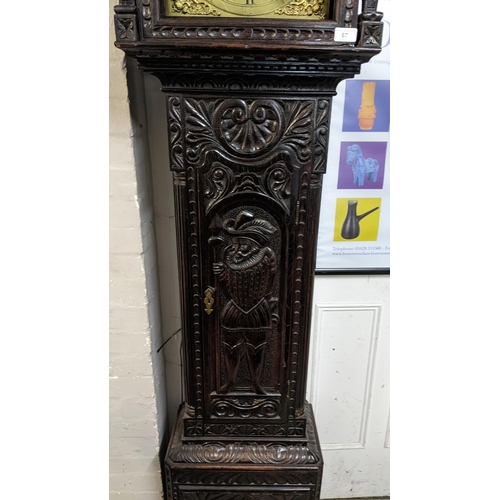 67 - An 18th century and later longcase clock, the heavily  carved oak case having broken swan neck pedim... 