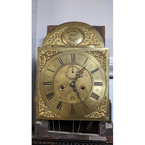 67 - An 18th century and later longcase clock, the heavily  carved oak case having broken swan neck pedim... 