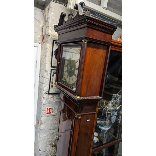 70 - A George III mahogany longcase clock, the case having a broken swan neck pediment above a dental mou... 