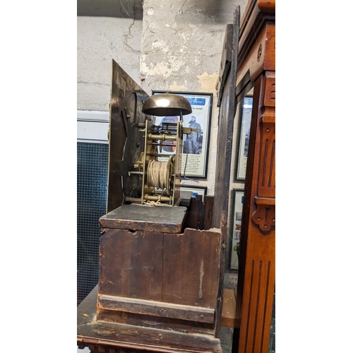 70 - A George III mahogany longcase clock, the case having a broken swan neck pediment above a dental mou... 