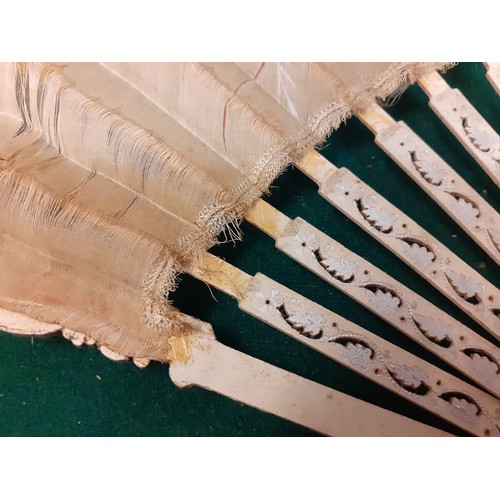 145 - A mixed lot comprising an Edwardian cream silk fan A/F, an early 20th Century cream silk beaded even... 