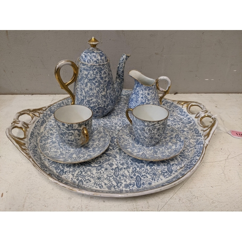 258 - An early 20th century cabaret set with two cups and saucers, a teapot, a cream jug and tray
Location... 