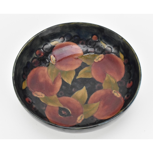 260 - A William Moorcroft (1872-1945) pottery bowl in the 'Pomegranate' pattern, circa 1935, of circular f... 