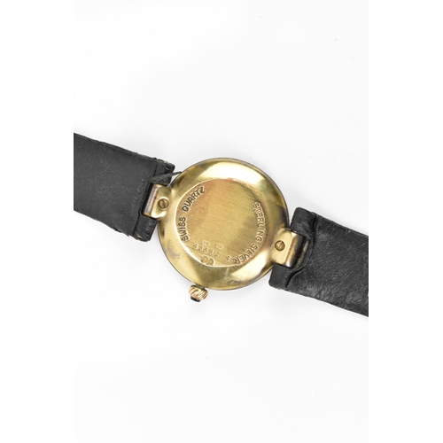 13 - A Dunhill, quartz, ladies, silver gilt wristwatch, having a textured gilt dial, Roman numerals, on a... 