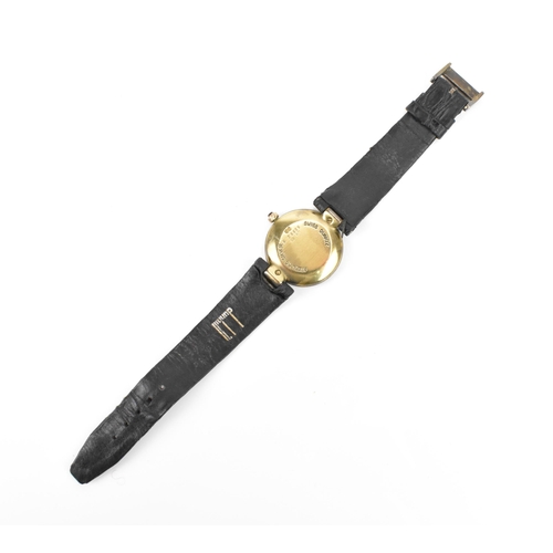 13 - A Dunhill, quartz, ladies, silver gilt wristwatch, having a textured gilt dial, Roman numerals, on a... 