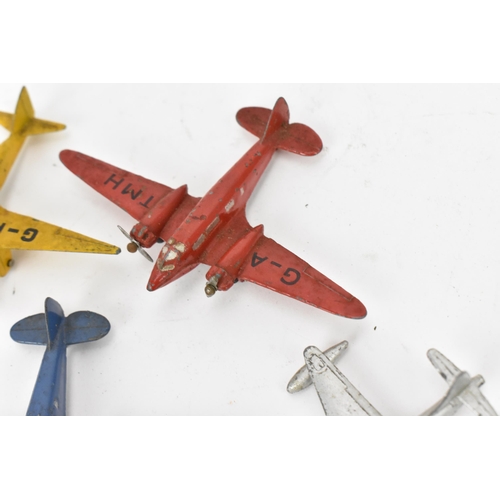 266 - A small collection of Dinky Toys aircraft to include a Light Racer in yellow, two Light Transport in... 