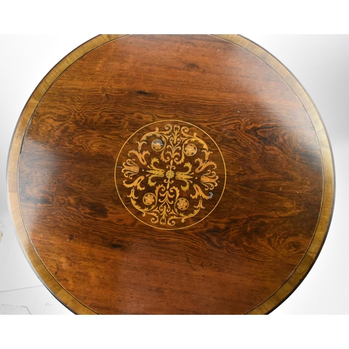 251 - An Edwardian rosewood inlaid tripod table, the circular top with foliate inlaid roundel, resting on ... 