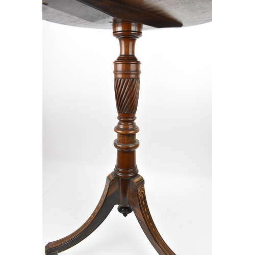 251 - An Edwardian rosewood inlaid tripod table, the circular top with foliate inlaid roundel, resting on ... 