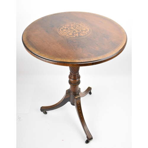 251 - An Edwardian rosewood inlaid tripod table, the circular top with foliate inlaid roundel, resting on ... 