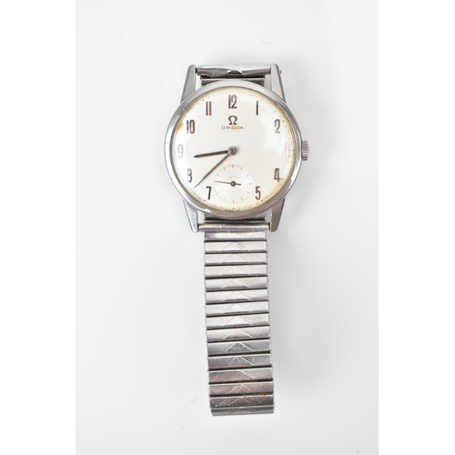 73 - An Omega, manual wind, gents, stainless steel wristwatch, having a silvered dial, subsidiary seconds... 