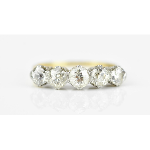 185A - An 18ct gold and five stone diamond ring, set with old cut diamonds in double claw setting, the cent... 