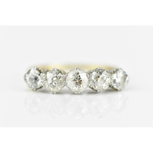 185A - An 18ct gold and five stone diamond ring, set with old cut diamonds in double claw setting, the cent... 