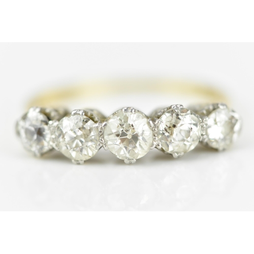 185A - An 18ct gold and five stone diamond ring, set with old cut diamonds in double claw setting, the cent... 