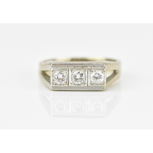 188A - An 18ct white gold and three stone diamond dress ring, set with three same-sized brilliant cut stone... 