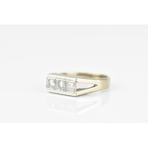 188A - An 18ct white gold and three stone diamond dress ring, set with three same-sized brilliant cut stone... 