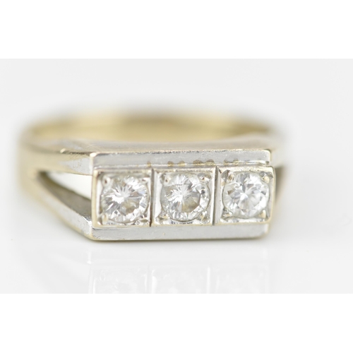 188A - An 18ct white gold and three stone diamond dress ring, set with three same-sized brilliant cut stone... 