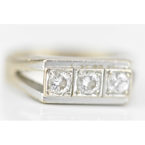 188A - An 18ct white gold and three stone diamond dress ring, set with three same-sized brilliant cut stone... 