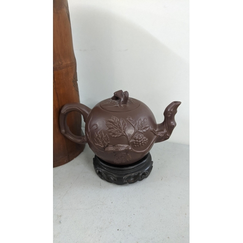 266 - An early 20th century Chinese carved bamboo brush pot together with Yixing teapot character marks to... 