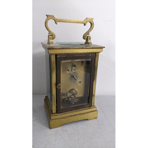 294 - A late 19th century brass carriage clock having platform lever escapement enamel dial with Roman num... 