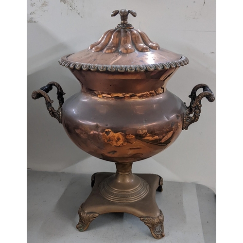 297 - A 19th century copper twin handled samovar having an egg and dart rim and raised on four scrolled fe... 