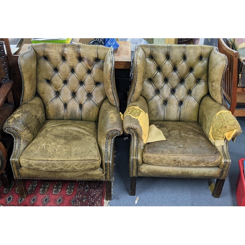 353 - A pair of mid 20th century green leather stud and button back upholstered wingback Chesterfield armc... 