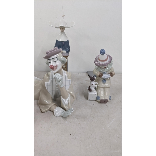 333 - A group of four Lladro figurines and one Lladro Nao figuring to include 4618 reclining clown with ba... 