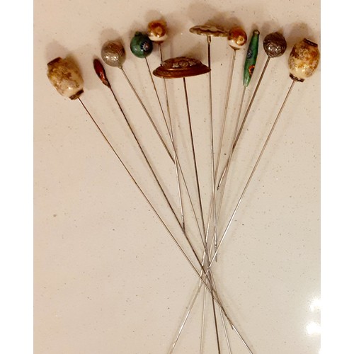 28 - Early 20th Century Oriental hat pins to include Satsuma glazed enamel examples, a pair of white meta... 