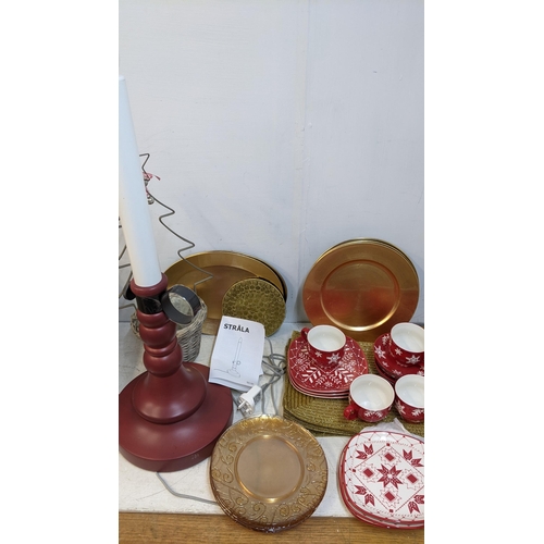 278 - Christmas related items to include Hausenware, cups, saucers, plates, place mats, a lamp fashioned a... 