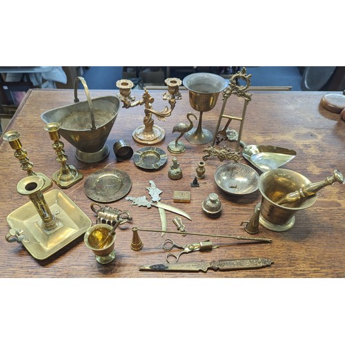 494 - Mixed brass and metalware items to include candle sticks, trophy, floral design photo frame, candle ... 