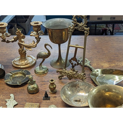 494 - Mixed brass and metalware items to include candle sticks, trophy, floral design photo frame, candle ... 